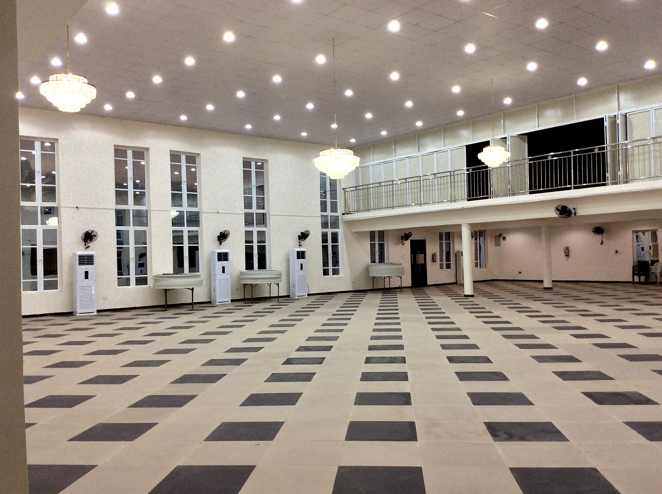 Grand hall showing tall windows and chandeliers